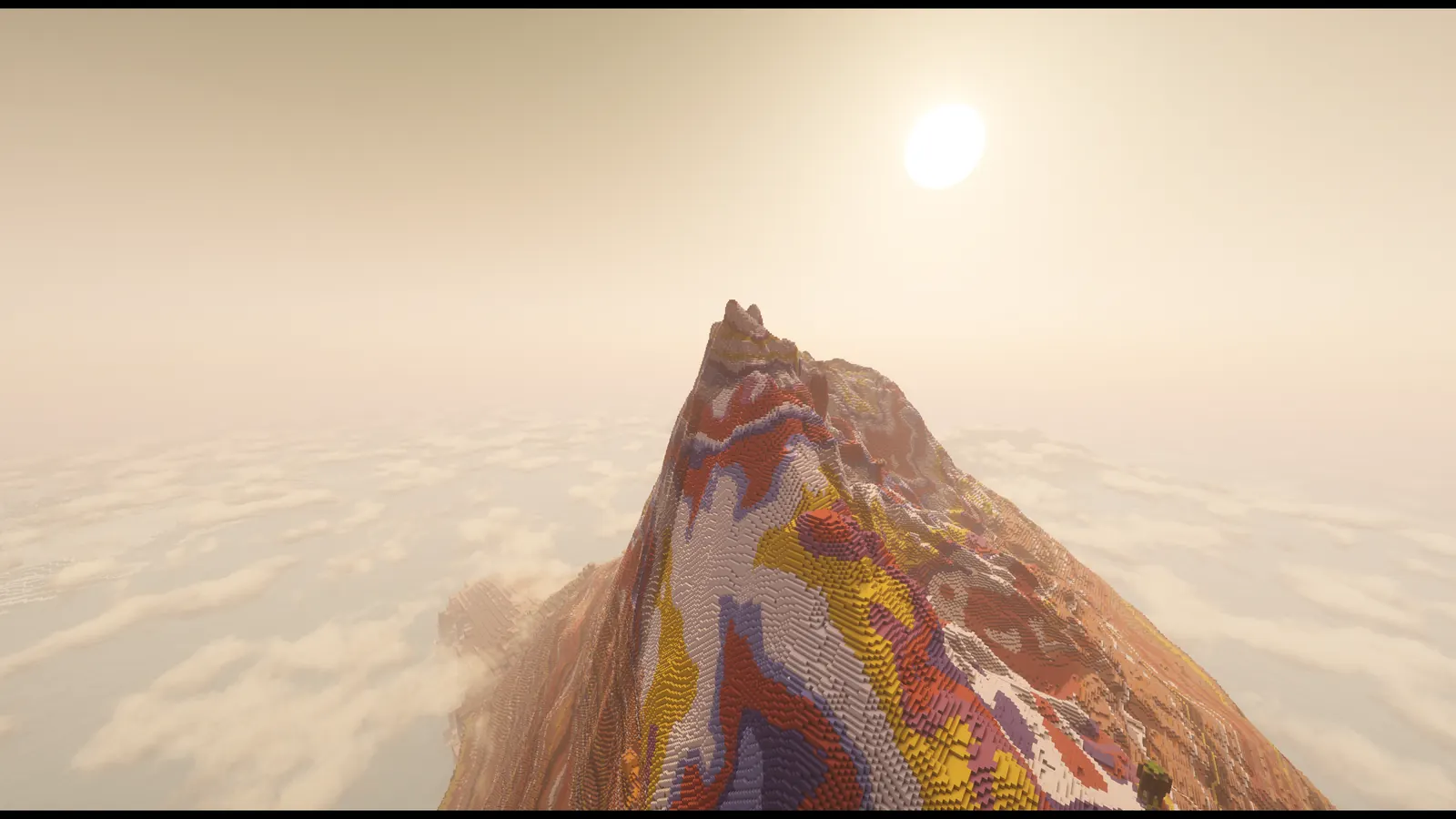 A ridge of red, yellow and white painted stone rising above a sea of clouds